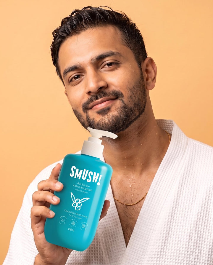 Man in a waffle robe holding Ape Escape Kokum Body Wash