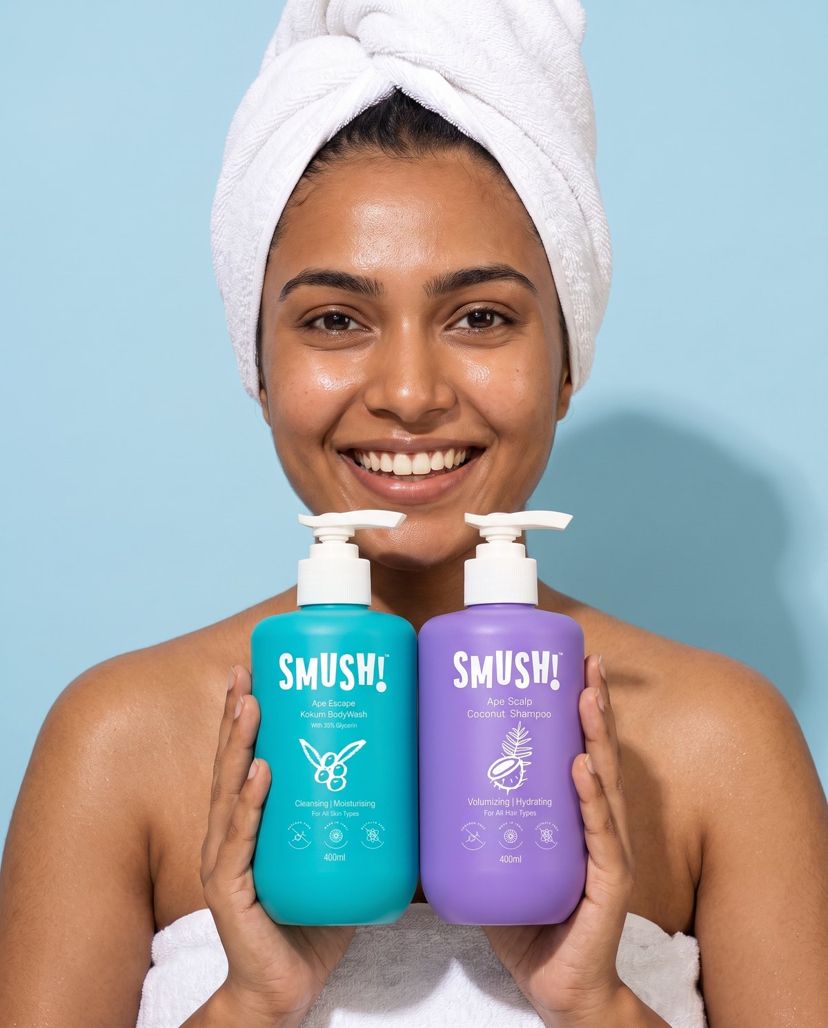 Woman in a towel turban holding the body wash and the shampoo