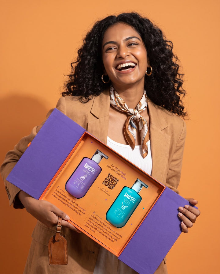 Woman laughing as she holds the open SMUSH! gift box