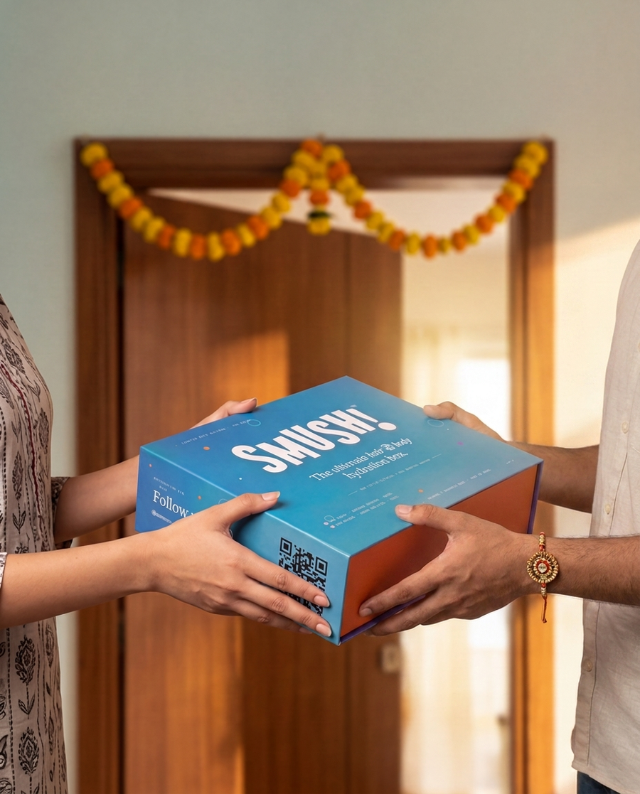 Handing over the SMUSH! gift box in a marigold-draped doorway