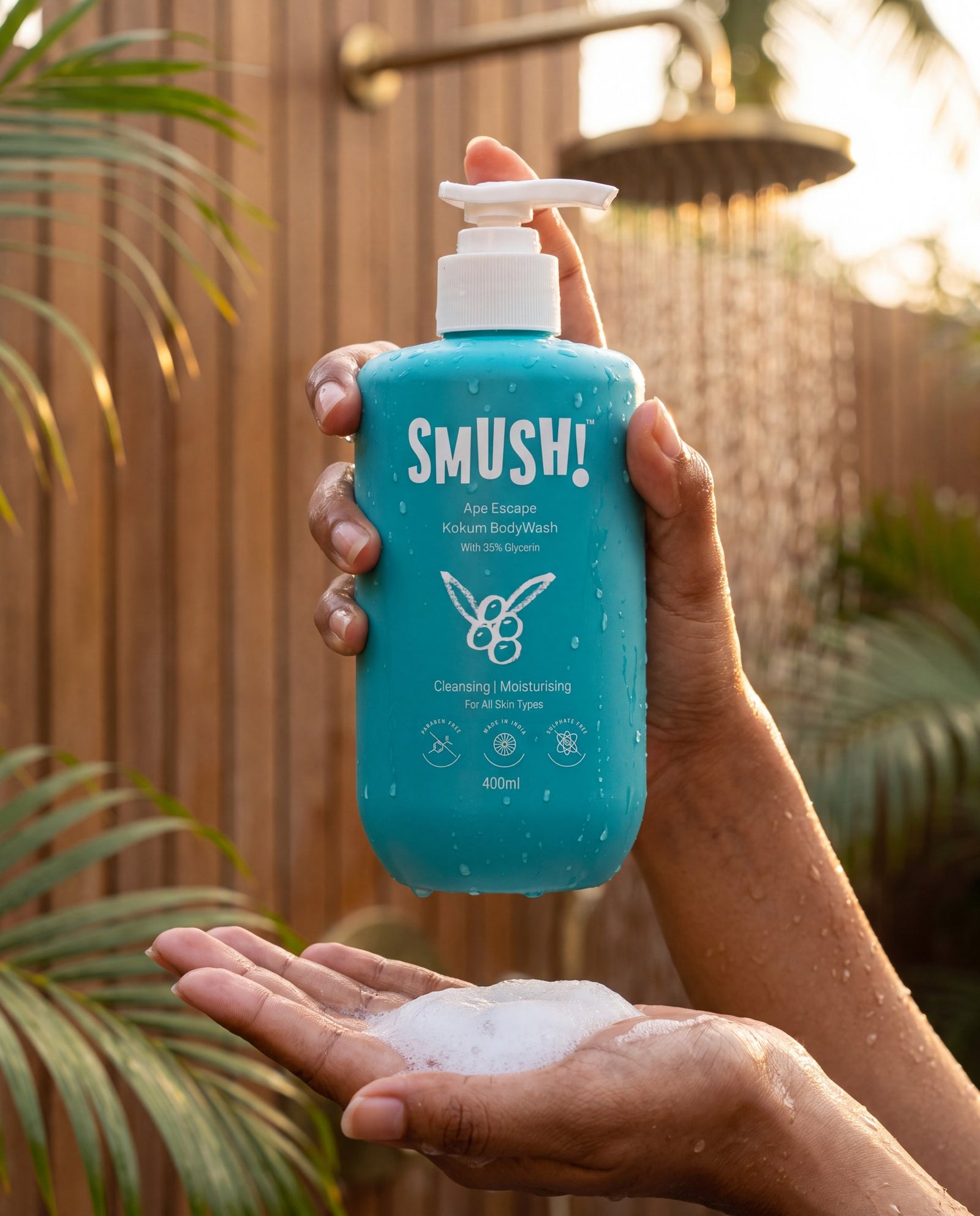 SMUSH! Ape Escape Kokum Body Wash held in an open-air shower, lather in the other hand