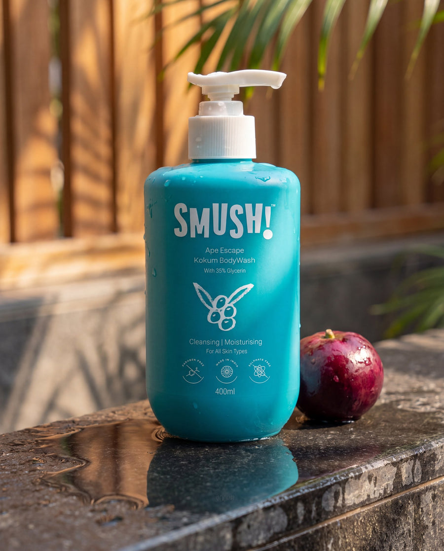 Ape Escape Kokum Body Wash on a wet stone ledge beside a kokum fruit