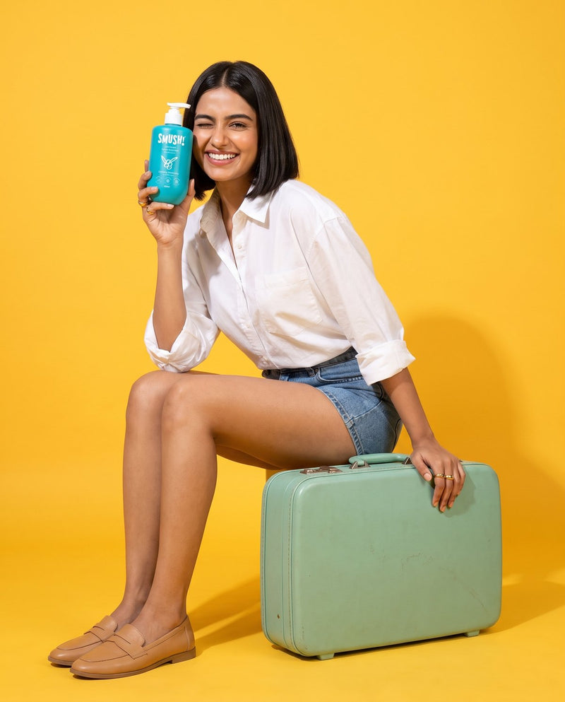 Woman on a mint suitcase holding Ape Escape Kokum Body Wash