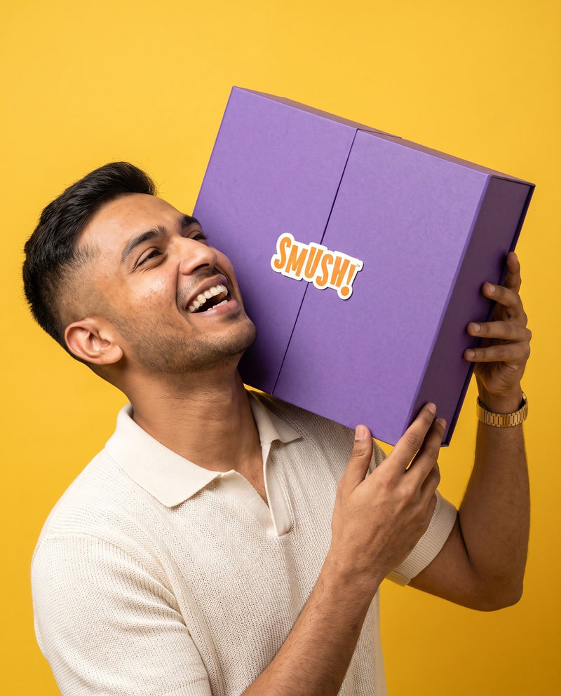 Man laughing with the SMUSH! gift box on his shoulder