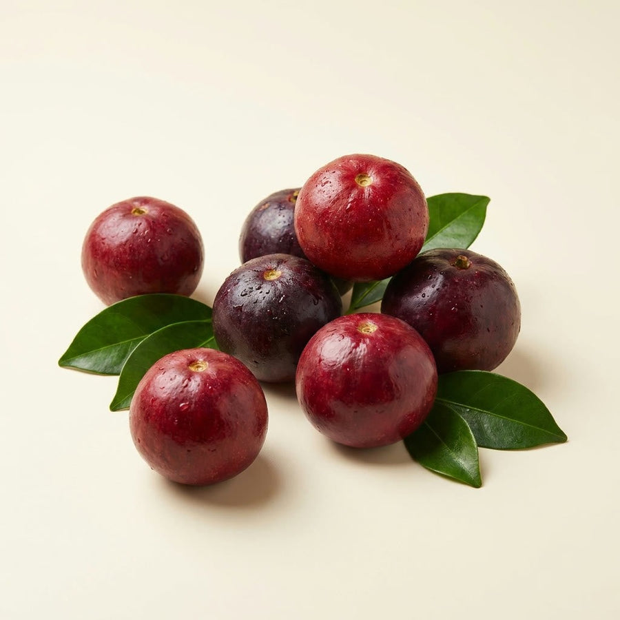 Whole kokum fruits with green leaves