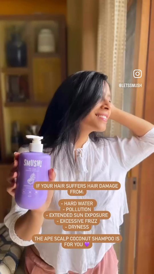 Video cover: A woman with soft, full dark hair holds up the purple Ape Scalp Coconut Shampoo