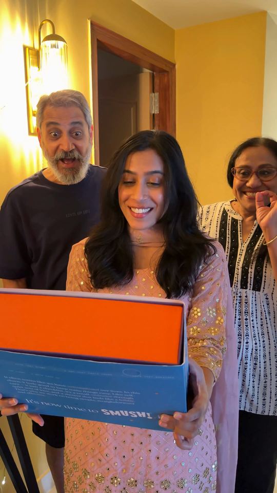 Video cover: A brother gives his sister the SMUSH! gift box, and the family opens it together