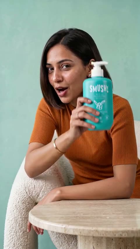 Video cover: A woman in an orange top pumps the teal SMUSH! Ape Escape Kokum Body Wash and holds the bottle up