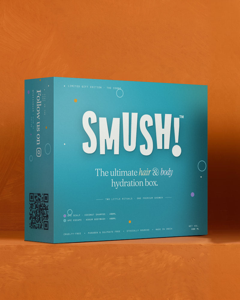 The SMUSH! gift box in its teal printed sleeve, the side panel reading Follow us on above a QR code, standing on a saffron ledge